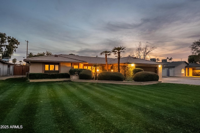 view of front of home featuring a garage and a yard