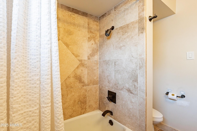 bathroom featuring shower / bath combo and toilet