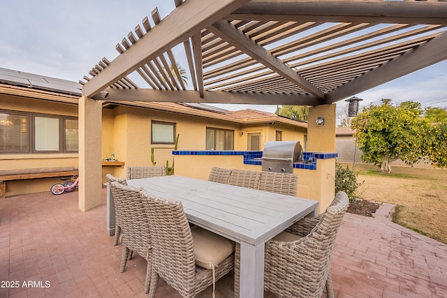 view of patio featuring area for grilling and a pergola