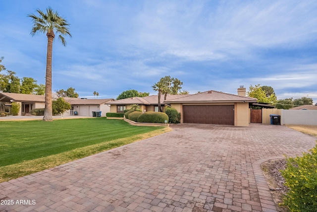 ranch-style house with a garage and a front lawn