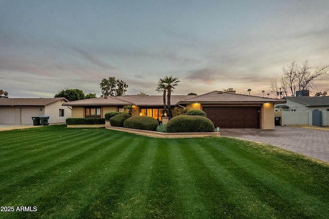 ranch-style home featuring a lawn