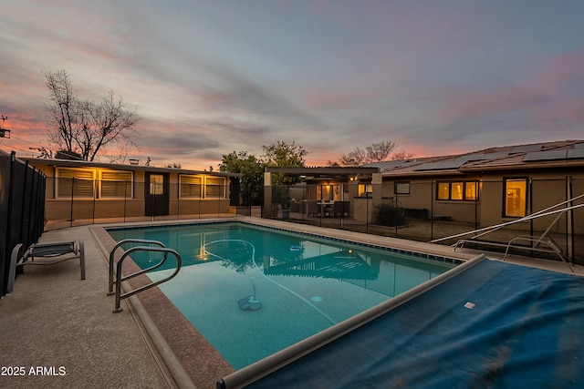 pool at dusk featuring a patio area