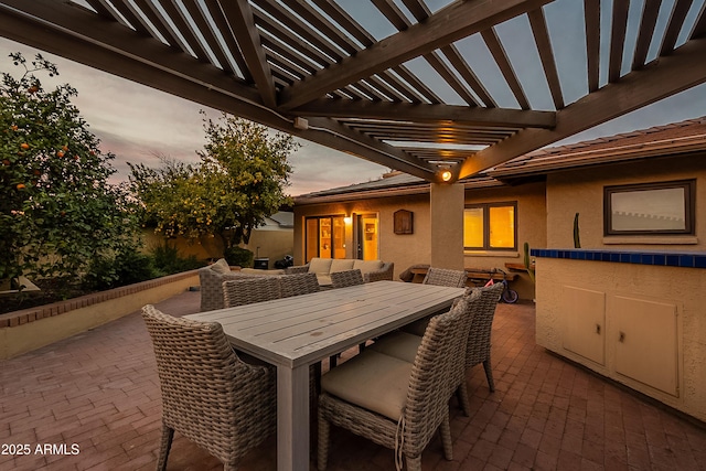 patio terrace at dusk with a pergola