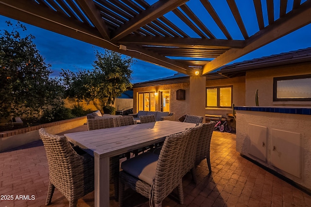 patio terrace at dusk with a pergola