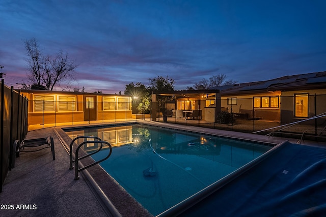 pool at dusk with a patio