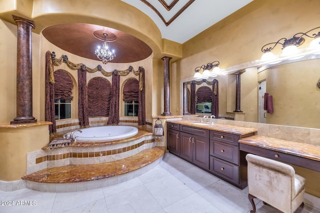 bathroom featuring ornate columns, an inviting chandelier, a relaxing tiled tub, tile patterned floors, and vanity