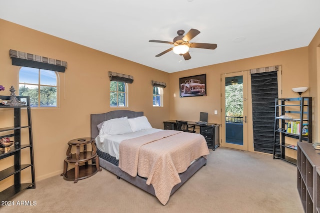 carpeted bedroom with access to exterior, multiple windows, and ceiling fan