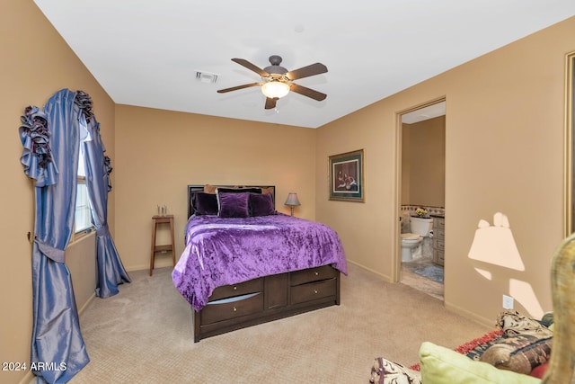 carpeted bedroom featuring ceiling fan and ensuite bath