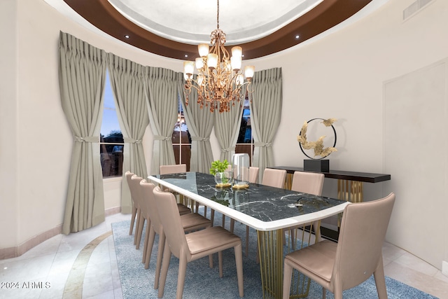 tiled dining room with a tray ceiling and an inviting chandelier