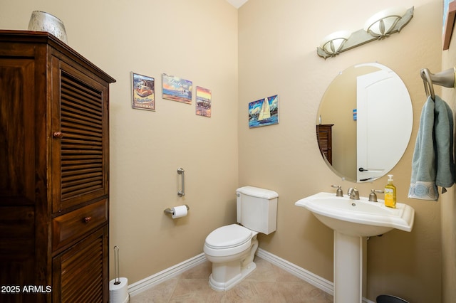 bathroom featuring tile patterned floors, toilet, and sink