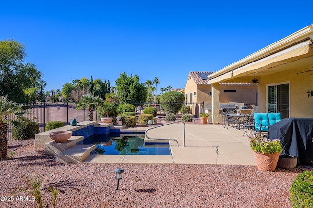 view of swimming pool with ceiling fan, area for grilling, and a patio