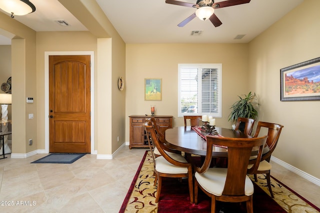 tiled dining space featuring ceiling fan