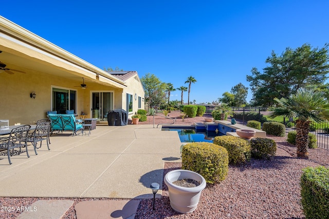 view of swimming pool with ceiling fan, a grill, and a patio