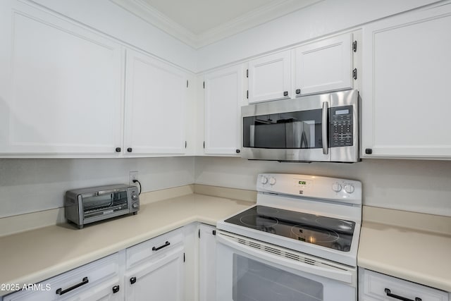 kitchen with white cabinetry, electric range, and crown molding