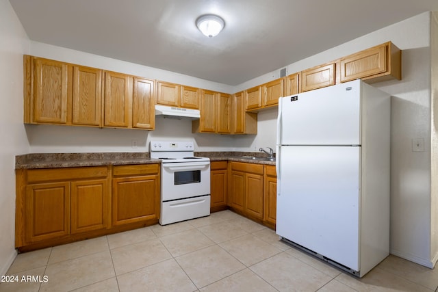 kitchen with light tile patterned flooring, white appliances, and sink