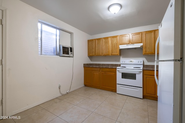 kitchen with white appliances, cooling unit, and light tile patterned floors