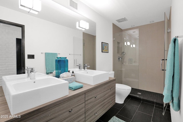 4800 N 68th St Unit 101, Scottsdale, AZ 85251 - full bath with a shower stall, toilet, double vanity, and tile patterned flooring