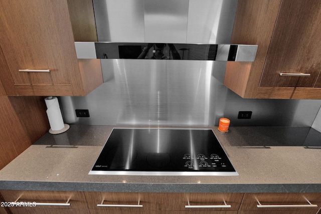 4800 N 68th St Unit 101, Scottsdale, AZ 85251 - kitchen view of exhaust hood, black electric cooktop, and brown cabinets