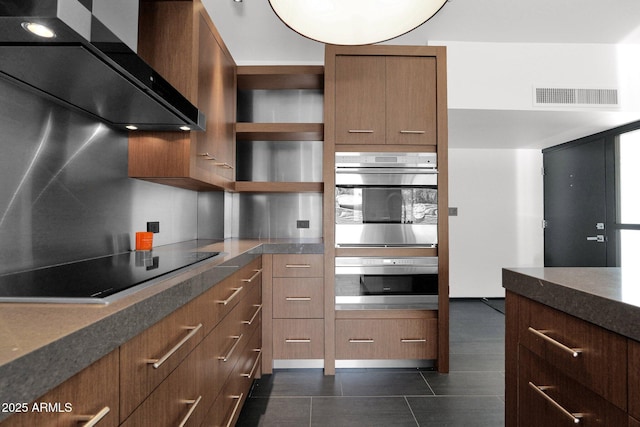 4800 N 68th St Unit 101, Scottsdale, AZ 85251 - kitchen featuring wall chimney exhaust hood, black electric stovetop, open shelves, brown cabinetry, and dark tile patterned floors