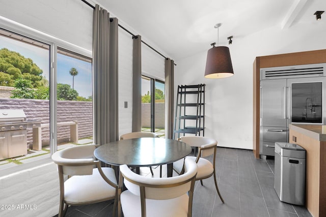 4800 N 68th St Unit 101, Scottsdale, AZ 85251 - dining space featuring lofted ceiling and dark tile patterned flooring