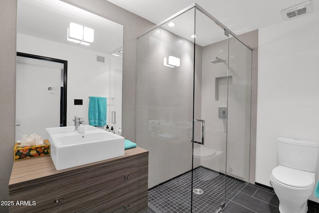 4800 N 68th St Unit 101, Scottsdale, AZ 85251 - bathroom with toilet, vanity, a shower stall, tile patterned flooring, and recessed lighting