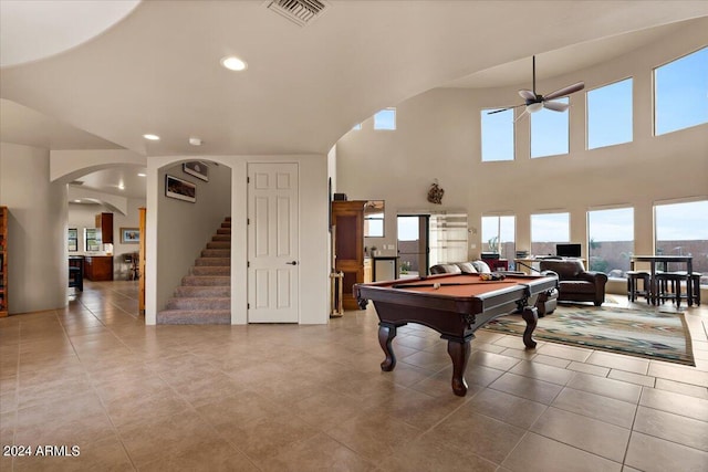 playroom with light tile floors, pool table, ceiling fan, and a towering ceiling