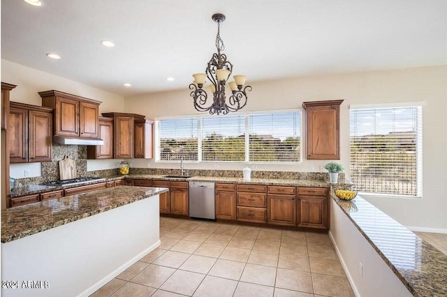 kitchen featuring light tile floors, sink, hanging light fixtures, stainless steel appliances, and an inviting chandelier