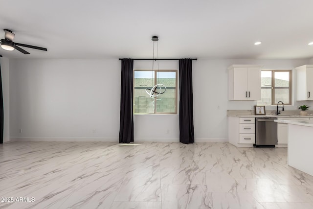 kitchen featuring baseboards, dishwasher, light countertops, white cabinetry, and recessed lighting