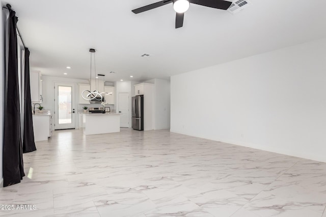 unfurnished living room with marble finish floor, recessed lighting, visible vents, and a ceiling fan