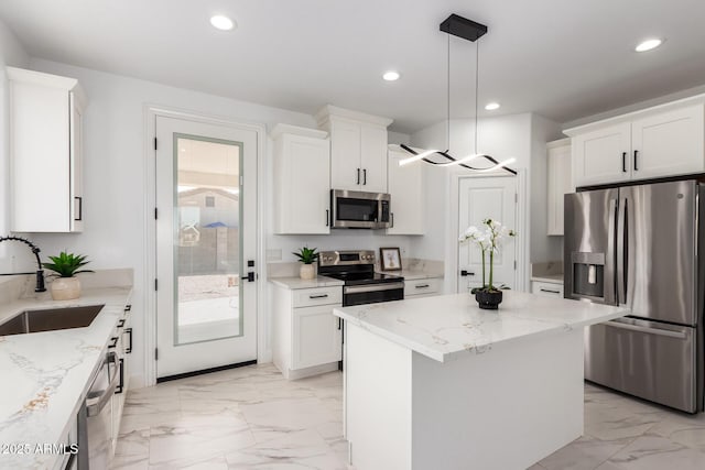 kitchen with appliances with stainless steel finishes, a sink, white cabinetry, and recessed lighting