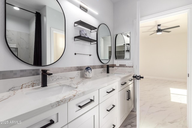 bathroom with ceiling fan, marble finish floor, double vanity, and a sink