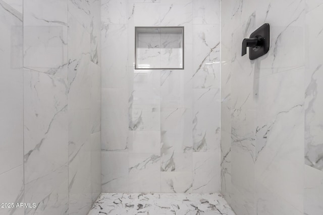 full bath with a marble finish shower