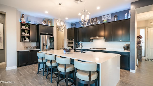 kitchen featuring under cabinet range hood, visible vents, appliances with stainless steel finishes, wood tiled floor, and open shelves