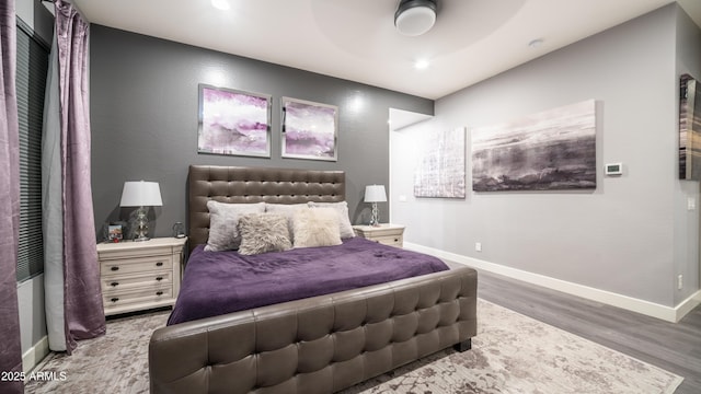 bedroom with recessed lighting, baseboards, and wood finished floors