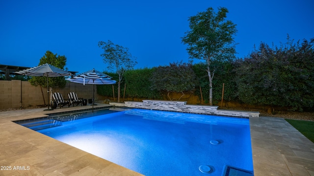 view of swimming pool featuring a fenced in pool, a fenced backyard, and a patio