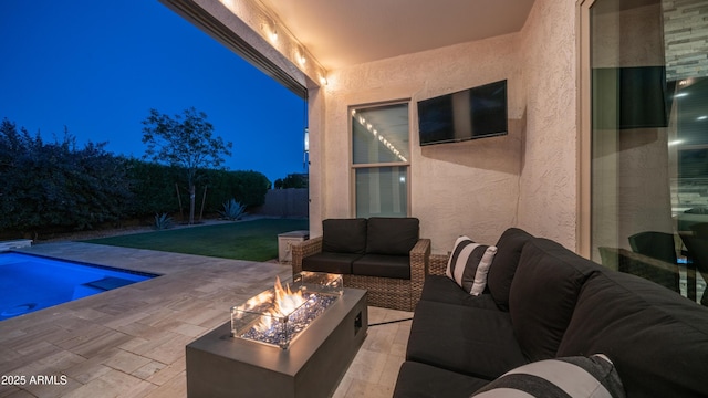 view of patio featuring a fenced in pool and an outdoor living space with a fire pit