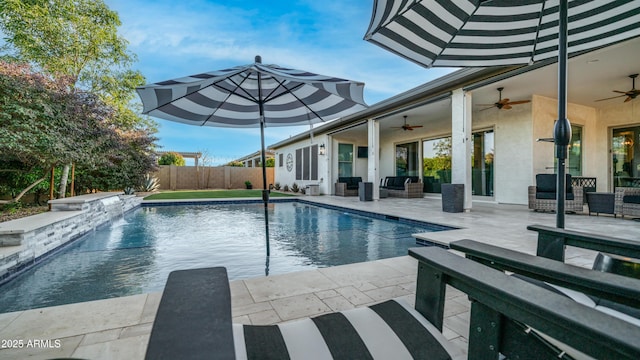 view of swimming pool featuring a fenced backyard, ceiling fan, a fenced in pool, and a patio