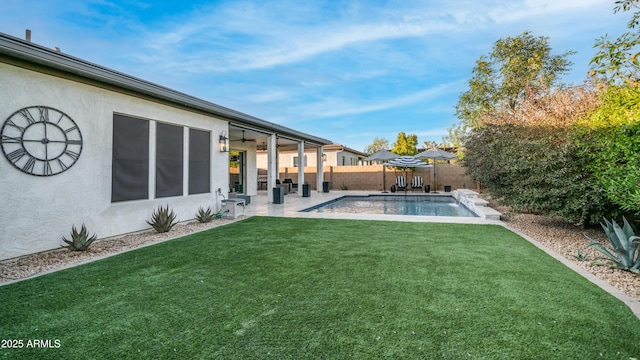 exterior space featuring a fenced in pool, a lawn, a ceiling fan, a patio area, and a fenced backyard