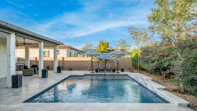 view of pool with a ceiling fan, a patio area, a fenced backyard, and a fenced in pool