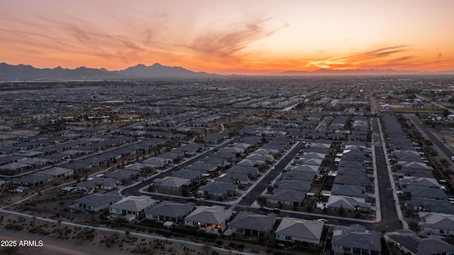 aerial view at dusk featuring a residential view and a mountain view