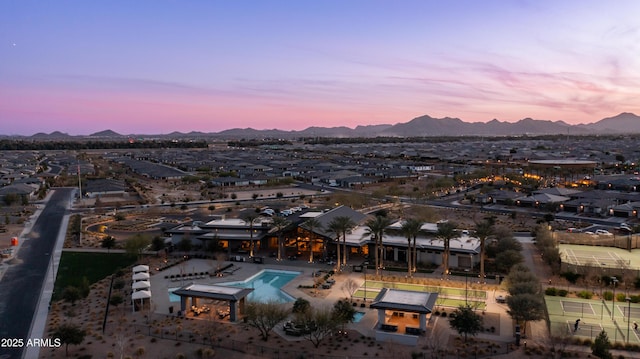 aerial view at dusk featuring a mountain view