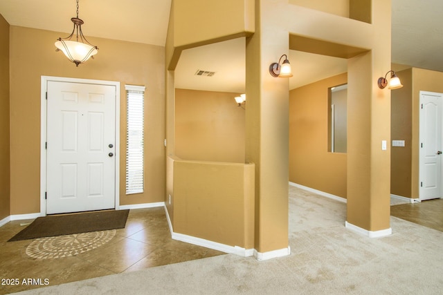 tiled entrance foyer featuring visible vents and baseboards