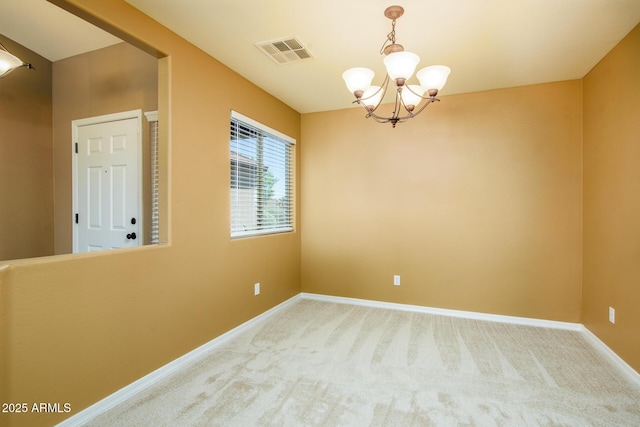 carpeted empty room with baseboards, visible vents, and a notable chandelier