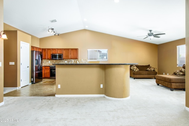 kitchen with stainless steel microwave, visible vents, open floor plan, fridge with ice dispenser, and light carpet