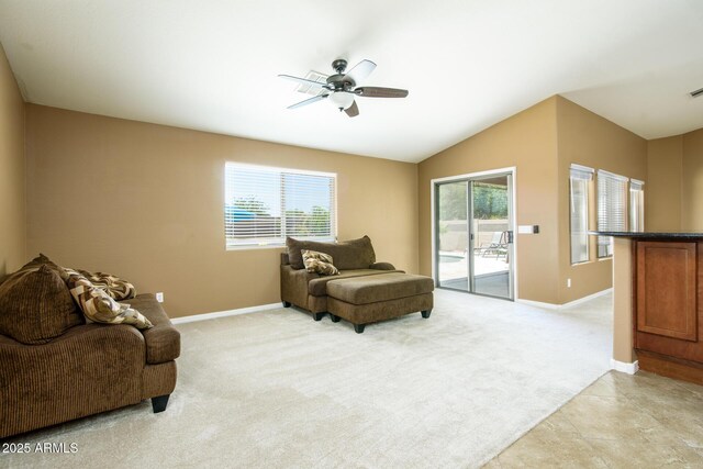living room with lofted ceiling, a ceiling fan, light carpet, and baseboards