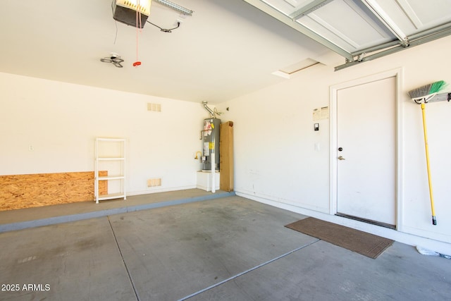 garage featuring a garage door opener and water heater