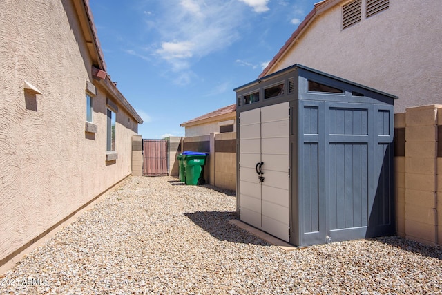 view of shed featuring a gate and fence