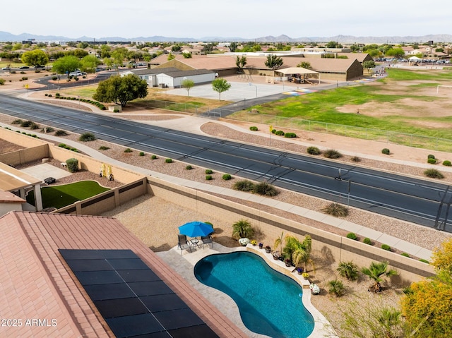 view of swimming pool featuring a mountain view and a fenced in pool