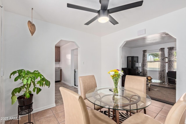 dining space with ceiling fan and light tile patterned floors