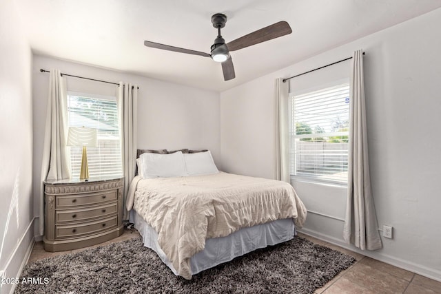 bedroom with tile patterned flooring and ceiling fan